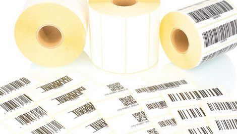 White label rolls and printed barcodes isolated on white backgro
