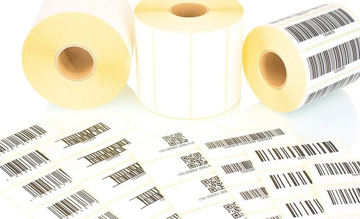 White label rolls and printed barcodes isolated on white backgro