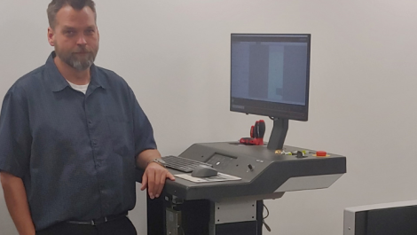 O.C. Tanner packaging engineer Daryl Leiser at the helm of the Kongsberg X24 Edge