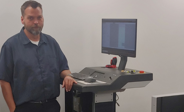 O.C. Tanner packaging engineer Daryl Leiser at the helm of the Kongsberg X24 Edge