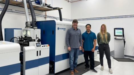 Label King's Robert Parker (owner and president), Yada Sousorn (press operator) and Turi Fiske (digital production and marketing manager) with the company's Domino N610i