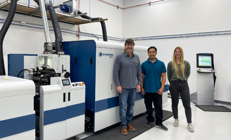 Label King's Robert Parker (owner and president), Yada Sousorn (press operator) and Turi Fiske (digital production and marketing manager) with the company's Domino N610i